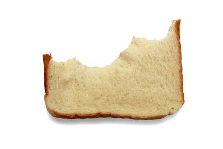 A piece of bread that have been bitten isolated on white background.