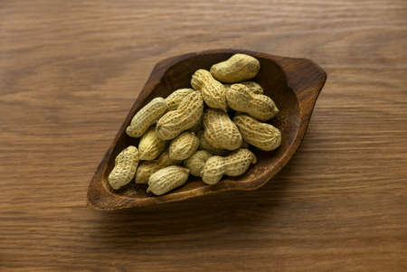 Dried peanut on wooden background.