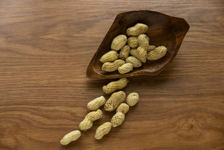 Dried peanut on wooden background.