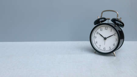 An alarm clock on a grey background with copy space.の写真素材