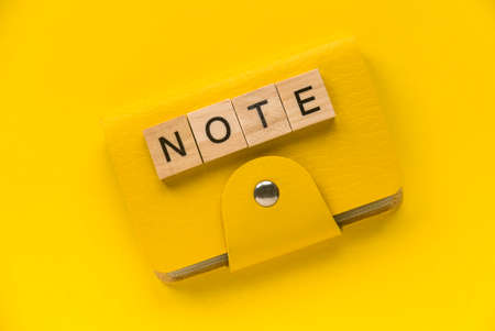 Yellow notebook with an alphabet of word note on yellow background.