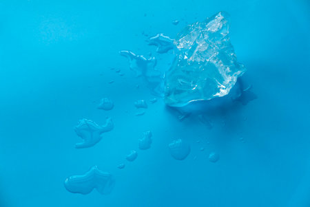 Ice and water on a blue background.の写真素材
