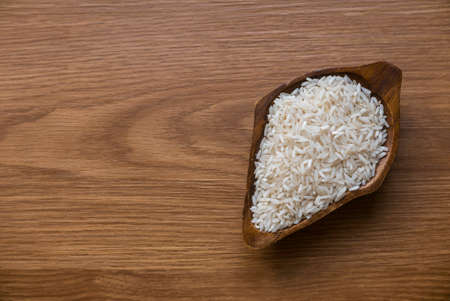 Selective focus of rice on wooden background with copy space.の写真素材
