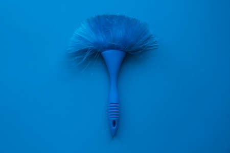 Blue cleaning brush on a blue background.の写真素材