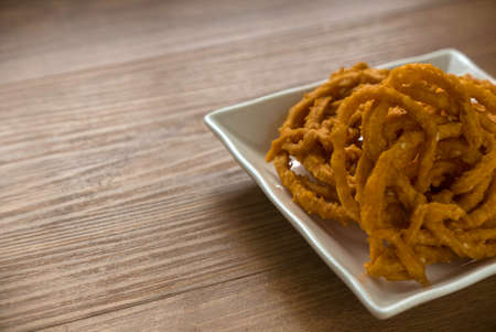 Murukku is a savory, crunchy snack originating from the Indian subcontinent.Its an Indian traditional tea time snack chakli, a deep fried snack, It is known as Chakali, Muruku, Murkoo, Chakri.の写真素材