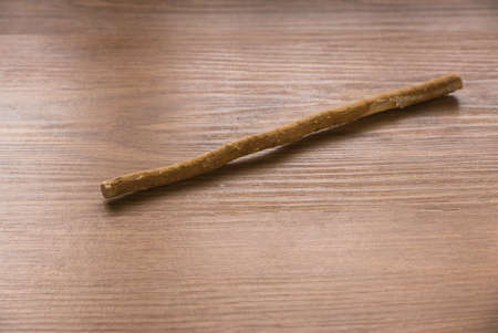 The miswak, miswaak, siwak, sewak, Arabic is a teeth cleaning twig made from the Salvadora persica tree. Miswak on wooden background.の写真素材
