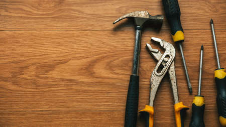 Set of repair tools on wooden background with copy space.の写真素材