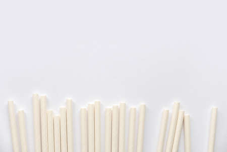 Biodegradable eco friendly white paper drinking straw isolated on white background with copy space.