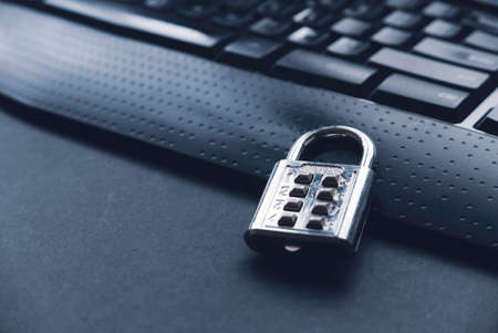 Computer security concept. A padlock on a computer keyboard.の写真素材