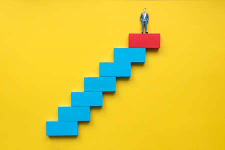A miniature businessman at the top of stairway. Concept of success business or career.の写真素材