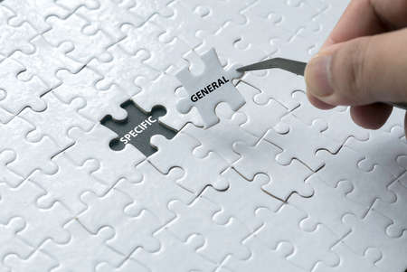 A hand pick a piece of jigsaw puzzle written with General and an empty space of jigsaw puzzle...