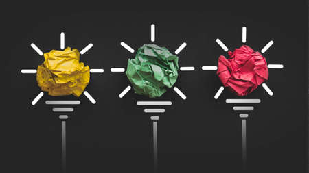 Inspiration concept. A colorful crumpled paper balls with a light bulb icon.