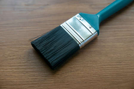 Paint brush on a wooden background.の写真素材