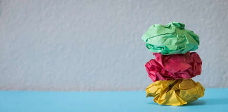 A stack of crumpled paper balls on a grey background with copy space.の写真素材