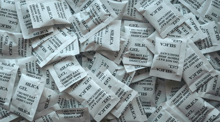 A bunch of desiccant or silica gel in white paper packaging.の写真素材