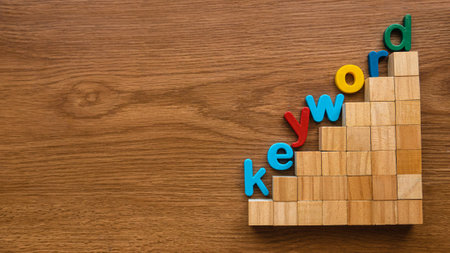 Colorful alphabet of word keyword on a ladder of wooden cube.の写真素材