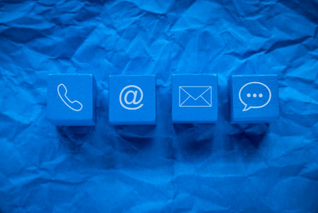 Icon of communication type on blue wooden cube. Contact us or Customer support hotline people connect.の写真素材