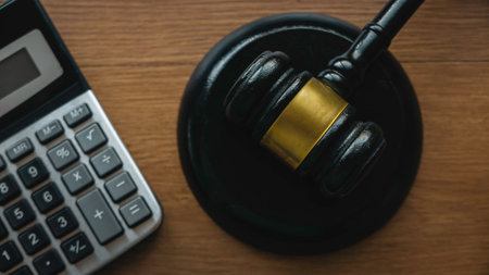 Law and finance. Bankcruptcy, tax law, bribe, corruption, arbitration, penalty concept.Gavel and calculator on a wooden background.の写真素材