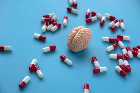 Concept of brain diseases, mental health, Alzheimer's, Parkinson's disease, dementia, stroke, and seizure. Nootropics use to improve memory and neural function. Brain model with a pills.の素材 [FY310202364923]