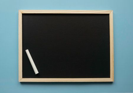 Empty chalkboard with chalk. Copy space.