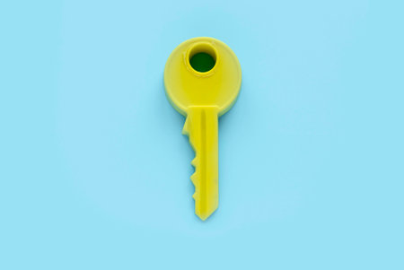 Yellow key isolated on a blue background.の写真素材