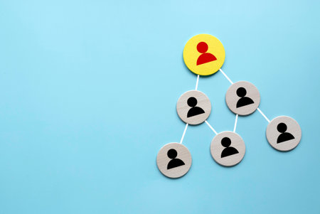 Company hierarchical organizational chart of wooden circle on blue background with copy space.の写真素材