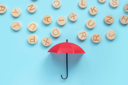 A red umbrella with a rain of alphabet.
