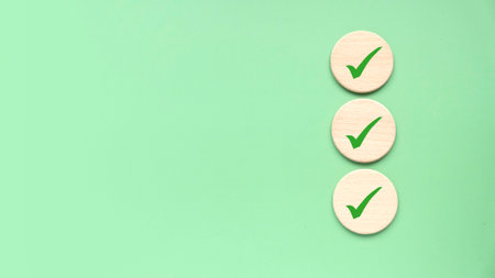 Checklist concept. Accomplishment of objectives or goals. To do list. Planning and verification. Checkmark over a green background. Copy space.の写真素材