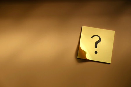 Questions and answer concept. Question mark written on paper. Brown silhouette shadow background.の写真素材