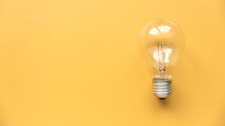 Creative thinking idea, innovation and inspiration concept. Bulb on yellow background. Copy space.