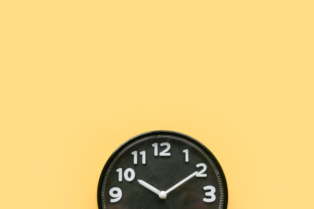 Concept of time, reminder, countdown, alert, deadline. Wall clock isolated on yellow background.Copy space.の写真素材