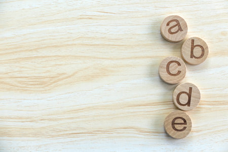 Education, learning and developement concept. Wooden alphabet of ABCDE on a wooden background. Copy space.の写真素材