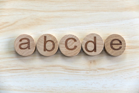 Education, learning and developement concept. Wooden alphabet of ABCDE on a wooden background.