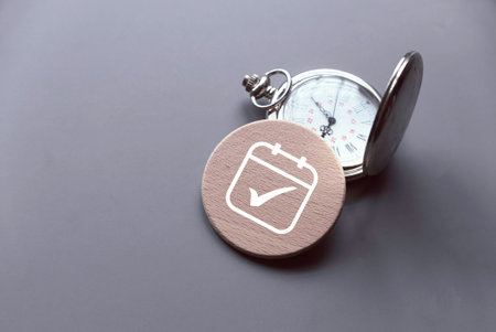 Concept of plan a monthly calendar for meetings or manage your daily activities. Calendar symbol with check mark over a watch.の写真素材