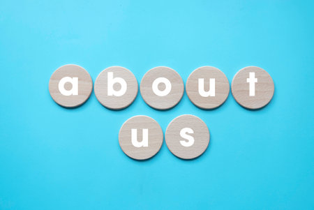 About Us Details Contact Data Information Communication Concept. wooden circle written with contact us over blue background.の写真素材
