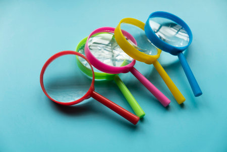 Colorful magnifying glass over a blue background.