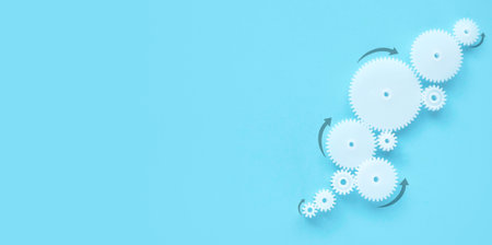 Concept of business process and workflow automation with flowchart.White gear wheel with an arrow on a blue background. Copy space.の写真素材