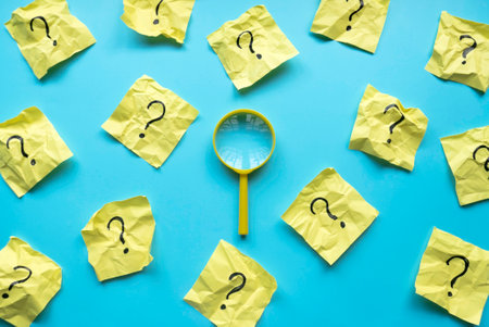 QnA or questions and answers concept. Yellow magnifying glass with question symbol on memo note over...