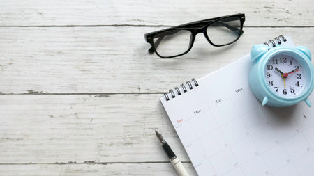 Concept of plan a monthly calendar for meetings or manage your daily activities.Wooden table. Copy space.の写真素材