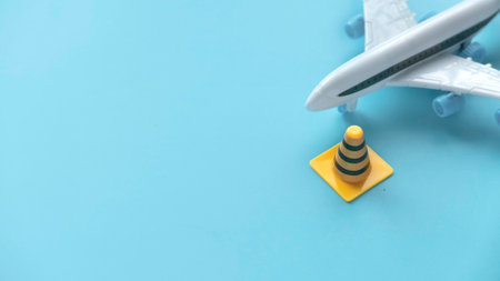 Fixing, maintenance and under construction concept. Traffic or safety cone with toy airplane.の写真素材