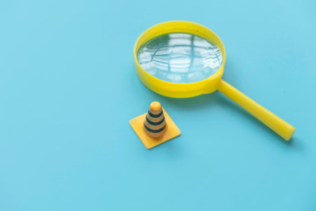 Fixing, maintenance and under construction concept. Magnifying glass with traffic cones.の写真素材