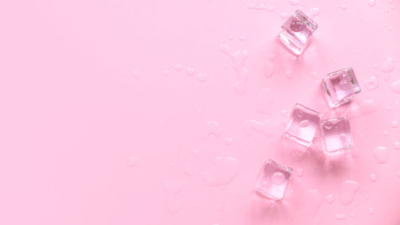 Concept of cold and refreshing. Ice cubes with water drops on a pink background.の写真素材