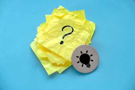 Concept of creative thinking idea and problem solving. Light bulb icon and question mark.の写真素材