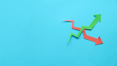 red and green arrow graph over a blue background. Copy space.の写真素材