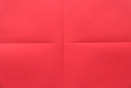Folded red color paper for background.の写真素材