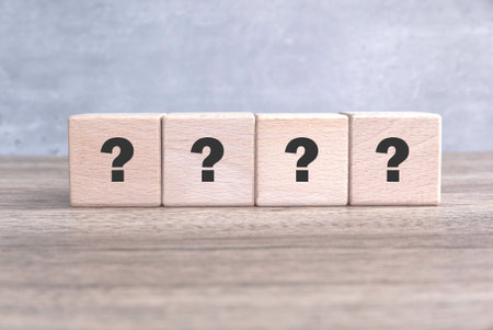 Wooden Cube with Question Mark Symbol on wooden table.の写真素材