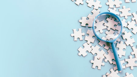 Magnifying Glass Over Jigsaw Puzzle Pieces for Detailed Inspection