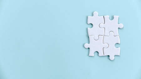 Four Jigsaw Puzzle Pieces Interlocking: Symbolizing Teamwork and Collaboration