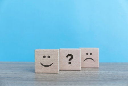 Exploring Emotions: The Journey from Happiness to Uncertainty in a Playful Wooden Cube Rowの写真素材