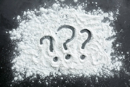 Question mark symbol written on a flour powder.の写真素材